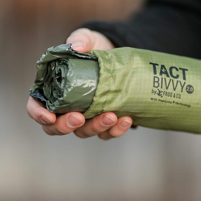 Survival Frog Tact Bivvy 2.0 Emergency Sleeping Bag w/Stuff Sack, Carabiner, Survival Whistle, ParaTinder - Compact, Lightweight, Waterproof, Reusable, Thermal Bivy Sack Cover, Shelter Kit